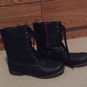 Black boots with red zipper.